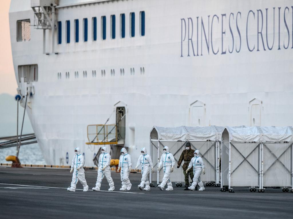 Emergency workers exit the Diamond Princess cruise ship at Daikoku Pier at Japan as it is quarantined with cases on board in February. Picture: Carl Court/Getty Images