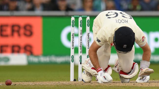 England’s captain Joe Root doubles over after being struck in a tender spot by a Mitchell Starc delivery. Picture: AFP