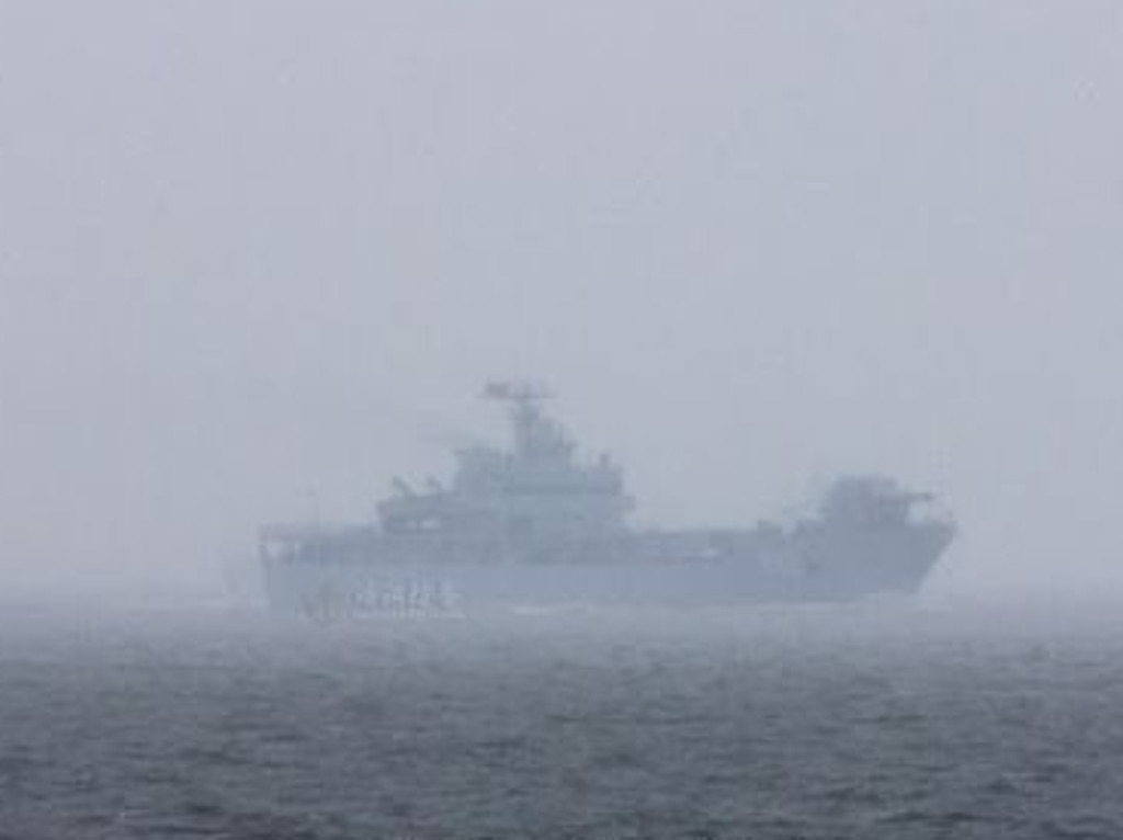 The experimental Chinese navy electromagnetic rail gun is seen at sea aboard a converted tank landing ship.