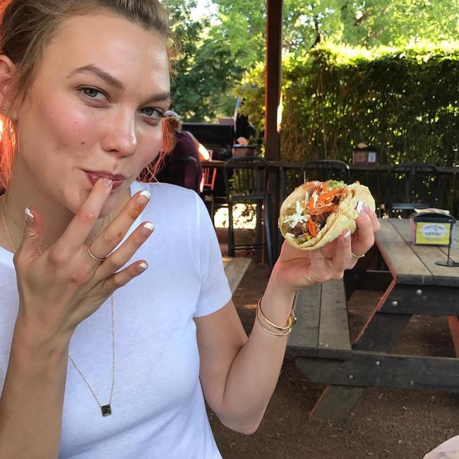 Stealing someone's taco in Texas, Karlie Kloss poses for a photo op... 
