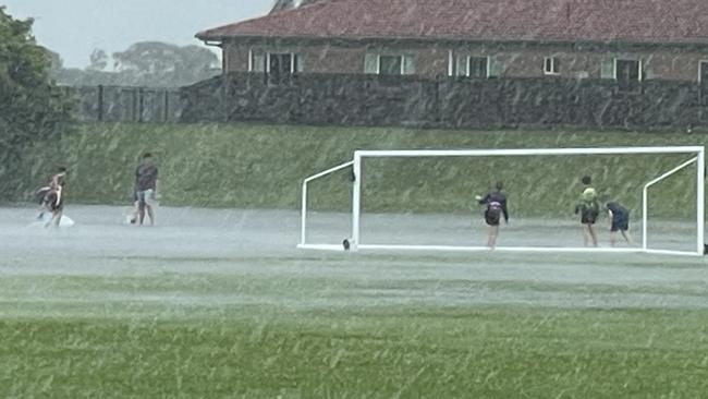 Children came to the Mackay Wanderers FC fields with boogie boards after they flooded overnight. Photo: Fergus Gregg