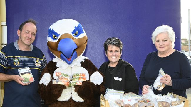 Prepared meals donated to Tony's Kitchen made by staff and students from Harristown State High School. From left; Tony hurle, Harry the Hawk, Tracey Waters, Catherine Jordan.