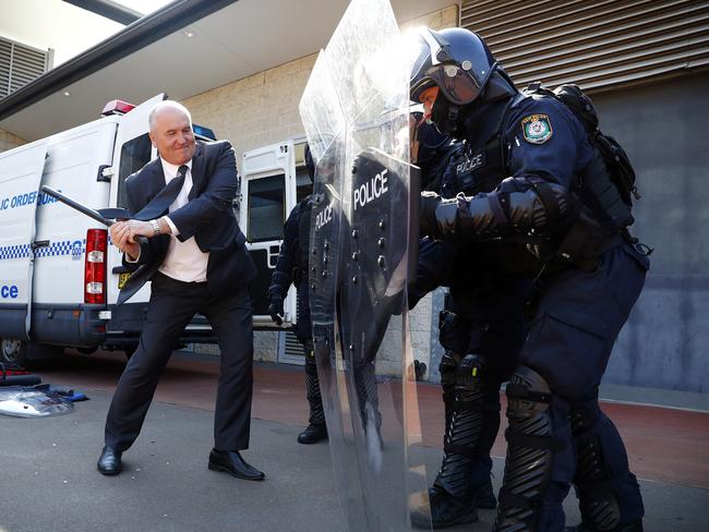 Police Minister doesn’t even make a dent as he tests out the riot squad’s protective shields. Picture: Sam Ruttyn