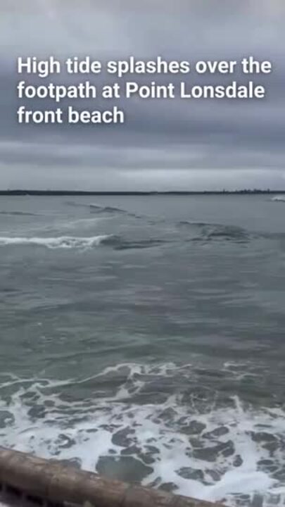 High tide splashes over footpath at Point Lonsdale front beach