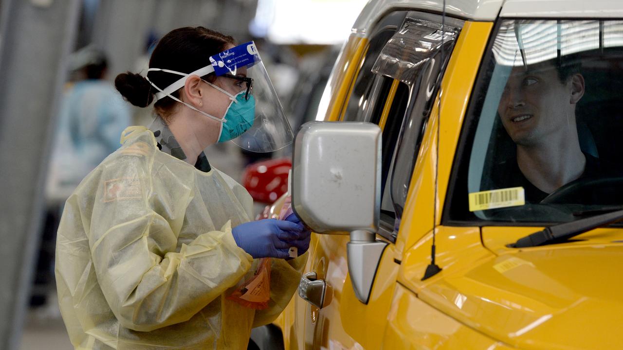 A member of the ADF assists with COVID-19 testing at Melbourne Showgrounds today. Picture: Andrew Henshaw