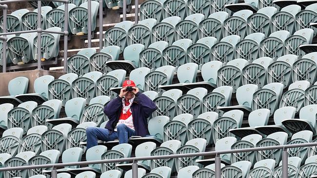 A lone crowd member at WIN Stadium for the last game to be played in front of spectators during the round one NRL match between St George Illawarra Dragons and Wests Tigers. Crowds were then banned, but restrictions have eased slightly. Picture: AAP