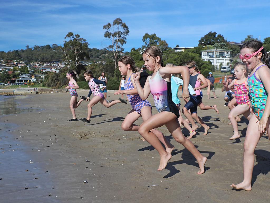 Participants competing in the Bupa KidFit Series triathlon at Blackmans Bay Beach. Picture: LUKE BOWDEN