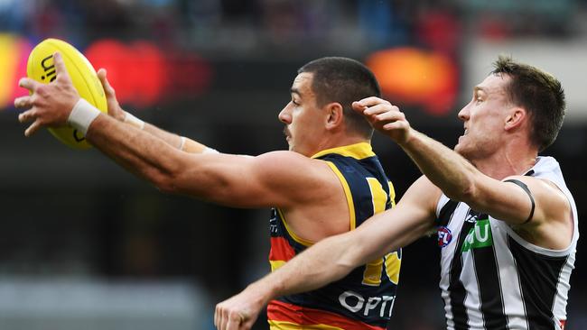 Taylor Walker marks in front of Collingwood’s Jack Madgen at Adelaide Oval in 2019. Picture: Mark Brake/Getty