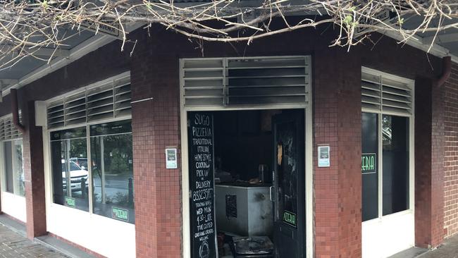 A family-run pizza shop at Dulwich had its front shop window smashed before being set alight.