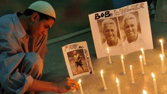 A Pakistani cricket fan lights candles to pay tribute to Woolmer in Karachi.