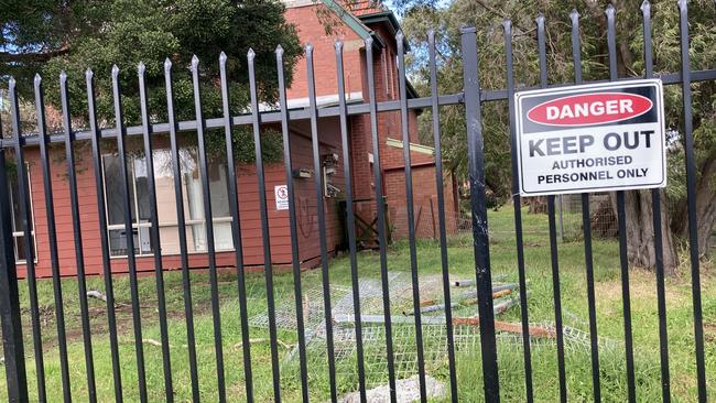 The former St Paul’s Boys Home is surrounded by a black fence and keep out signs. Picture: Brooke Grebert-Craig