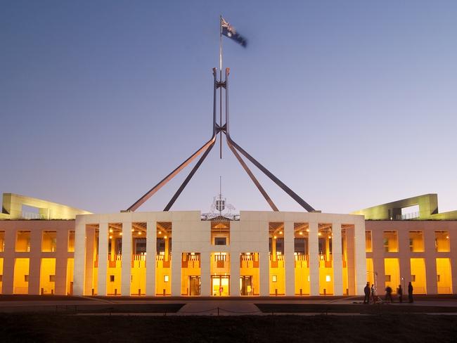 Parliament House in Canberra, Australia, illuminated at dusk.