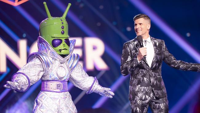 The Masked Singer host Osher Gunsberg with one of the show's mystery celebrity contestants. Picture: Channel 10.