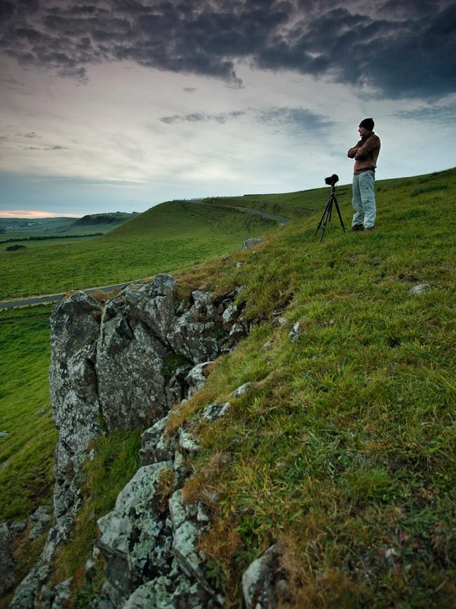 Photographer David Murphy overlooking the green hills at Stanley. Picture: Garth Smith