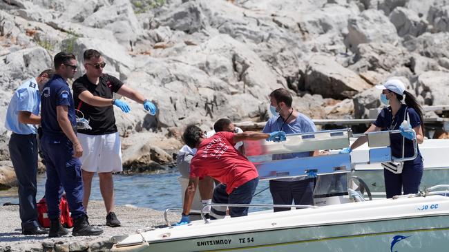 Emergency services lift an empty stretcher off a boat at Agia Marina in Symi, Greece. Picture: PA Images via Getty Images.