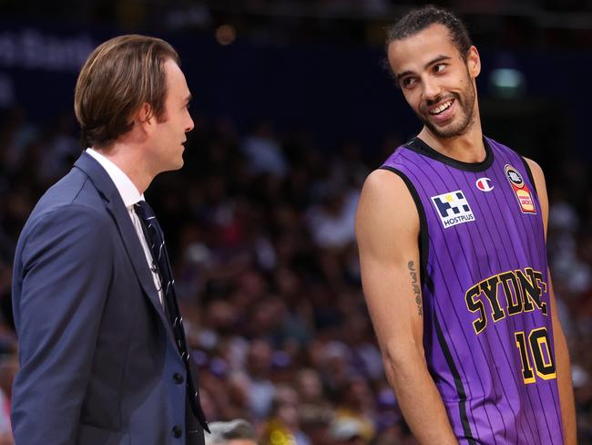 SYDNEY, AUSTRALIA - MARCH 10:  Xavier Cooks of the kings and  Kings head coach Chase Buford smile during game three of the NBL Grand Final series between Sydney Kings and New Zealand Breakers at Qudos Bank Arena, on March 10, 2023, in Sydney, Australia. (Photo by Mark Metcalfe/Getty Images)