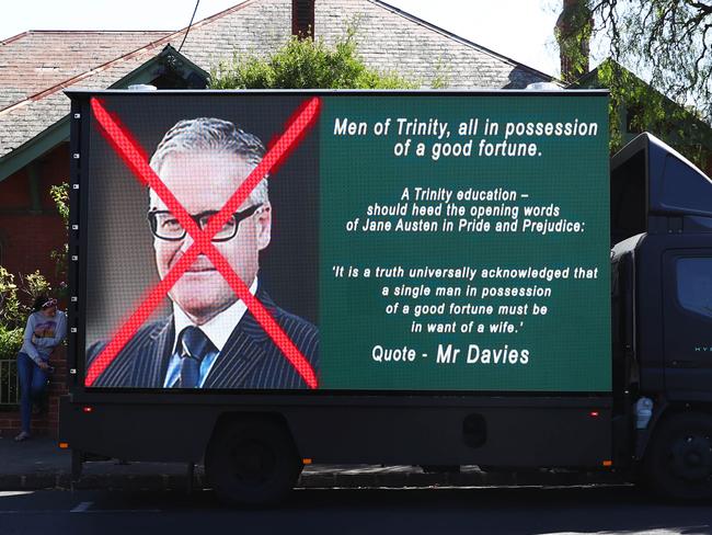 Trucks with billboards outside the Trinity Grammar school in Kew. Picture: Aaron Francis/The Australian