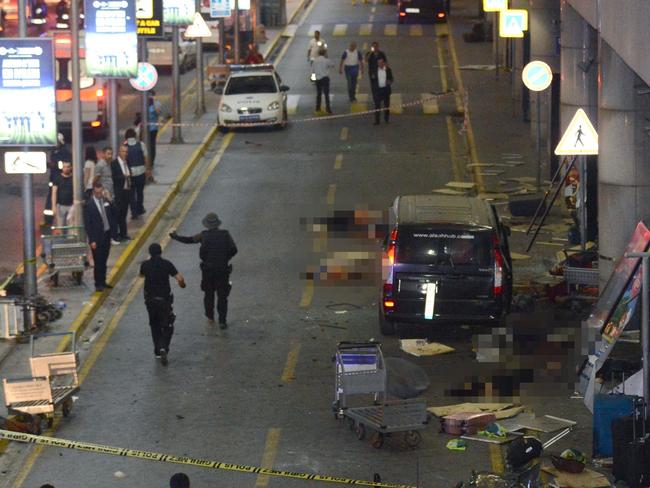 EDITORS NOTE: Graphic content / This picture obtained from the Ilhas News Agency shows injured people lying on the ground next to a terminal, after two explosions followed by gunfire hit the Turkey's biggest airport of Ataturk in Istabul, on June 28, 2016. At least 10 people were killed on June 28, 2016 evening in a suicide attack at the international terminal of Istanbul's Ataturk airport, Turkish Justice Minister Bekir Bozdag said. Turkey has been hit by a string of deadly attacks in the past year, blamed on both Kurdish rebels and the Islamic State jihadist group. / AFP PHOTO / ILHAS NEWS AGENCY / Handout / Turkey OUT