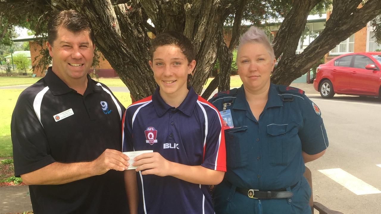 Talented AFL player, Declan Laverty is presented a cheque for $500 by Local Ambulance Committee president, Anthony Keating. Pictured with his mum and Chinchilla Ambulance Services officer, Samara Laverty.