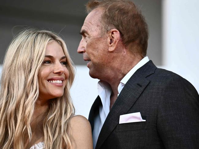 With Kevin Costner, right, on the red carpet in Venice. Picture: AFP