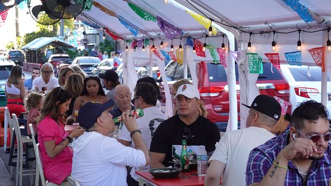 People enjoy a restaurant as they visit the Wynwood area on December 3 in Miami, Florida.