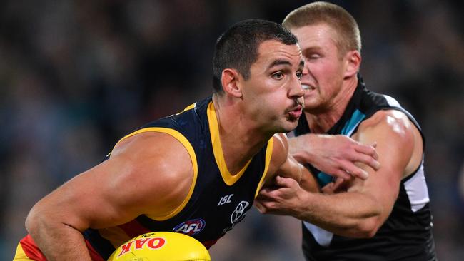 Crows co-captain Taylor Walker fends off Tom Clurey on Saturday night. Picture: AAP Image/David Mariuz