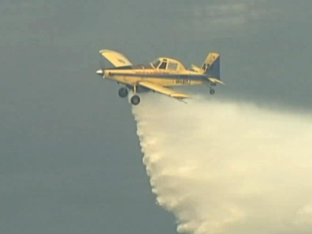 A NSW water bomber will join the fire fighting artillery on Monday, making it the 18th aircraft to try to dampen the blaze. Picture: Channel 9