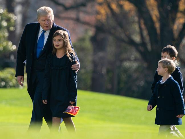 US President Donald Trump, followed by his grandchildren, Arabella, Theodore, and Joseph