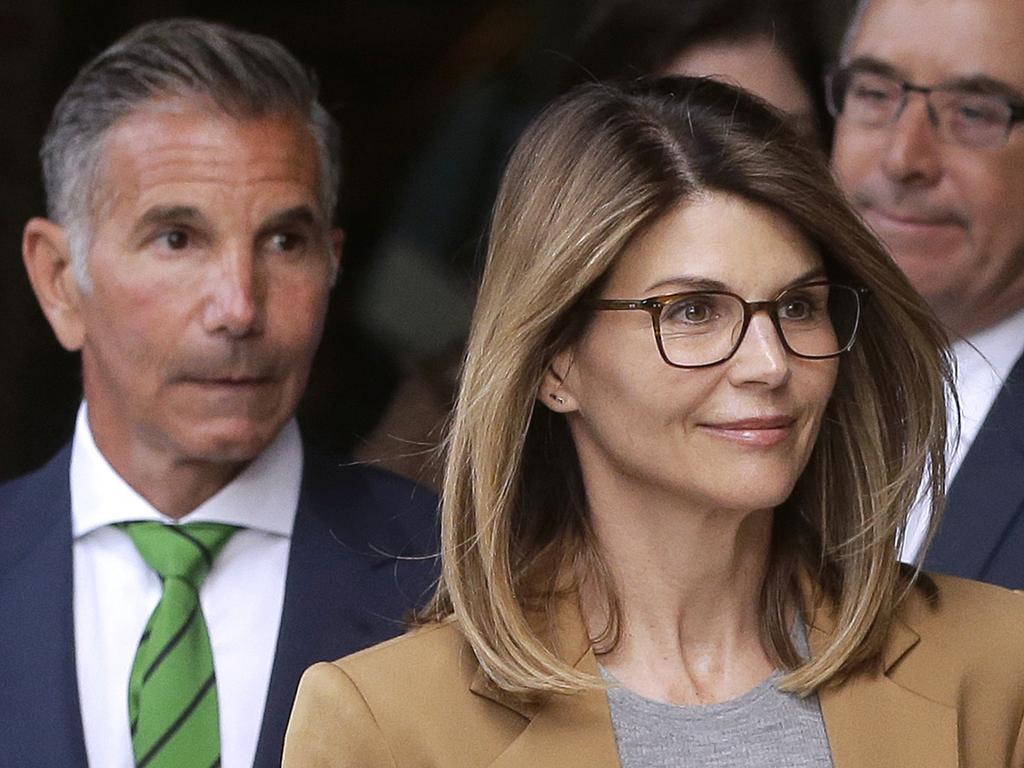 Lori Loughlin, front, and husband, clothing designer Mossimo Giannulli, left, depart federal court after facing charges in a college admissions bribery scandal. Picture: AP Photo