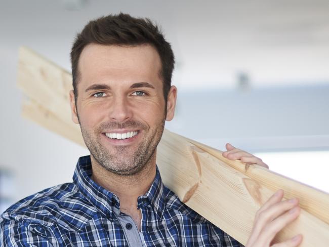 A tradesman who is carrying sticks of timber while he is doing home renovations. Picture: iStock.