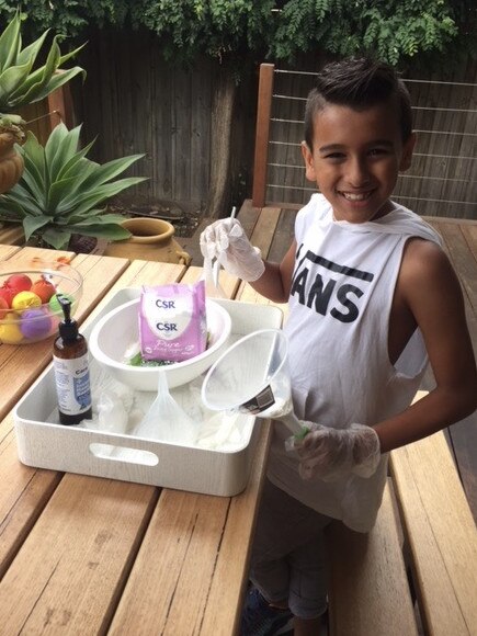 Dylan Nelson, 8, making stress balls for frontline workers.