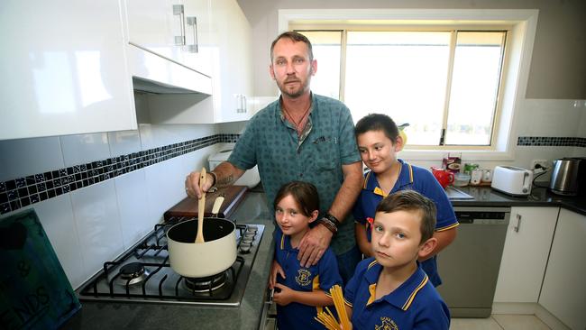 Single dad Sean Herrett with his children Harley, 10, Jorja 8 and Jensen 7 at their home in Goulburn.