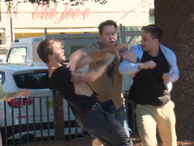 Photographer Dylan Robinson and a member of the public scuffle after a Fraser Anning press conference. Picture: Andrew Leeson/AAP