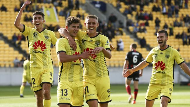 The Phoenix celebrate after Liberato Cacace settled the win. Photo: Hagen Hopkins/Getty Images)