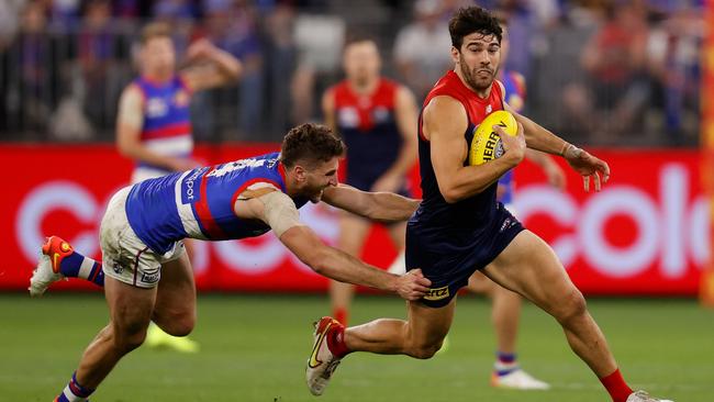 Christian Petracca evades the clutches of Marcus Bontempelli.