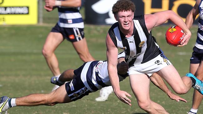 Wangaratta’s Tyler Norton eludes a tackle from Yarrawonga’s Harry Wheeler. Picture: Yuri Kouzmin