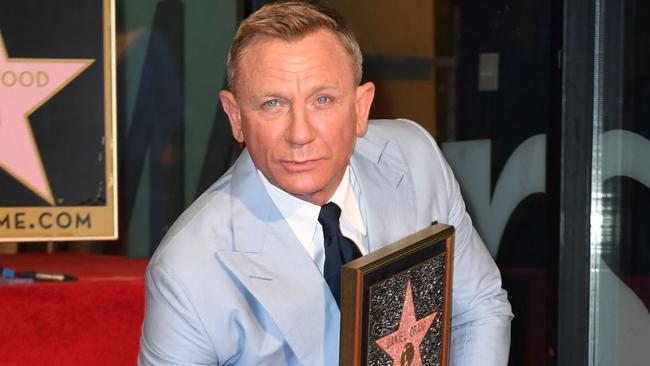 British actor Daniel Craig poses with his star during the ceremony to honour him with a star on the Hollywood Walk of Fame in Los Angeles, California. Picture: AFP