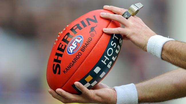 Generic image of the umpire holding the ball, during the Round 16 AFL match between the Richmond Tigers and the Brisbane Lions at the MCG in Melbourne, Saturday, July 5, 2014. (AAP Image/Joe Castro) NO ARCHIVING, EDITORIAL USE ONLY