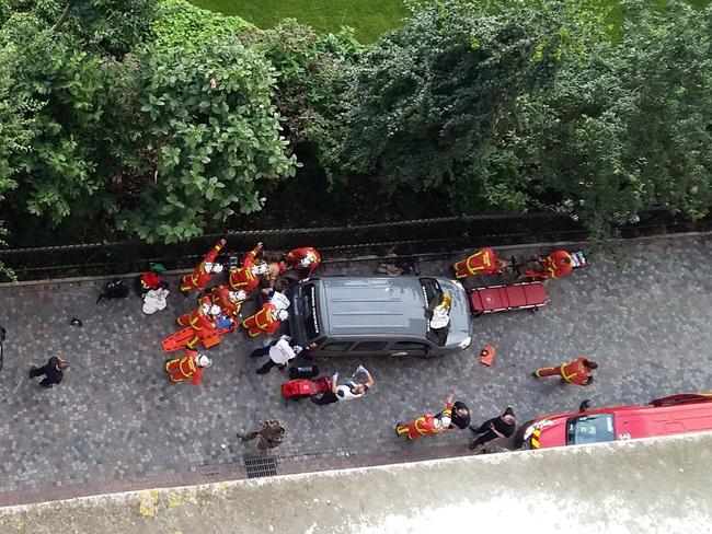 Officials and rescuers gather near vehicles after a car slammed into soldiers on patrol in Levallois-Perret, outside Paris on August 9, 2017 injuring six, two of them seriously, police in the French capital said. The vehicle took off after the incident, at about 8:00 am (0600 GMT) in the northwestern suburb of Levallois-Perret. Picture: AFP