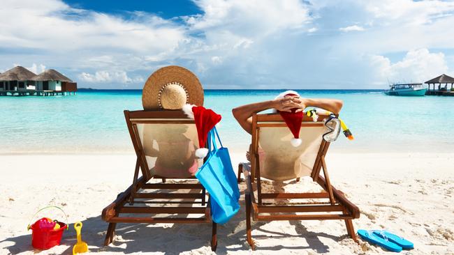 A couple taking a Christmas break at an overseas beach destination.