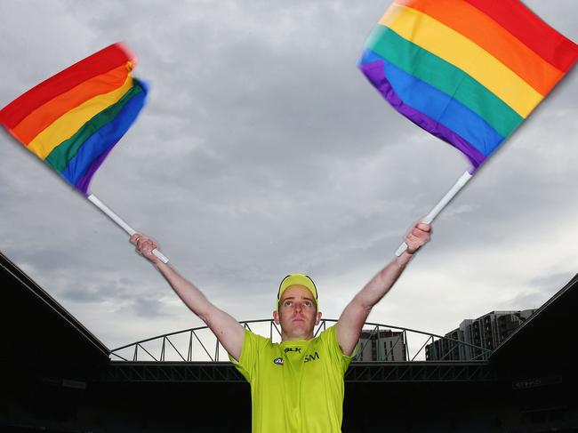 MELBOURNE, AUSTRALIA - AUGUST 09:  AFL Goal umpire Michael Craig waves the Pride Game rainbow goal umpire flag during an AFL media opportunity at Etihad Stadium on August 9, 2016 in Melbourne, Australia. St.Kilda Saints will play Sydney Swans in the Pride Game on the weekend.  (Photo by Michael Dodge/Getty Images)