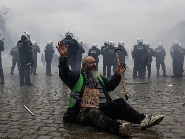 A demonstrator sits near a police line during the European Demonstration for Democracy protest against Covid-related measures in Brussels, Belgium on January 23. Picture: Bloomberg via Getty Images