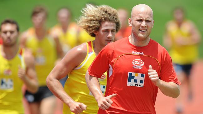 The new skipper leads his Suns teammates on the track during ahead of the 2011 AFL season. Picture: Matt Roberts/Getty Images