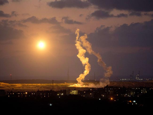 A photo taken on July 15, 2014 from the southern Israeli Gaza border shows Israeli army flares falling into the Palestinian enclave. AFP PHOTO/MENAHEM KAHANA
