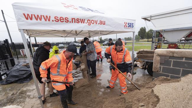 SES volunteers, some of whom have worked overnight, fill sandbags for local residents at the Penrith branch of the SES on Saturday morning. Picture: Brook Mitchell/Getty