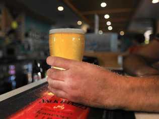 Person drinking beer at the bar. Picture: Scott Powick