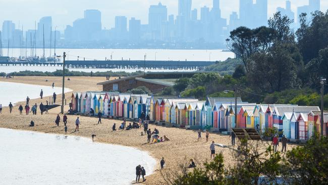 People sunbathing at Brighton Beach, which is not allowed under stage four restrictions. Picture: Jay Town