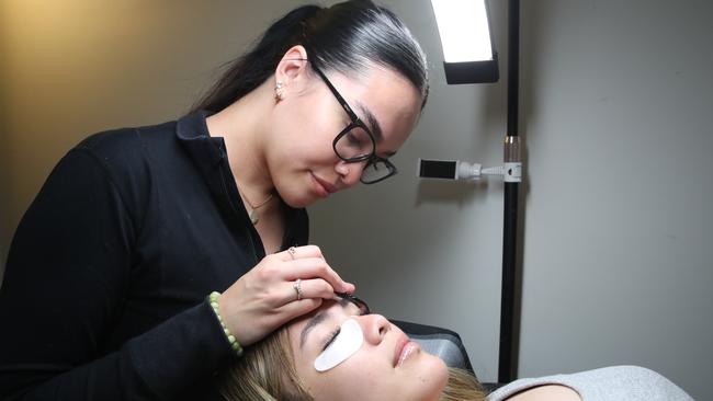 Eiffel Beauty owner Paris Hei has been named as a finalist for the best eyelash technician on the Gold Coast. Paris Hei with a client at her home base. Picture Glenn Hampson