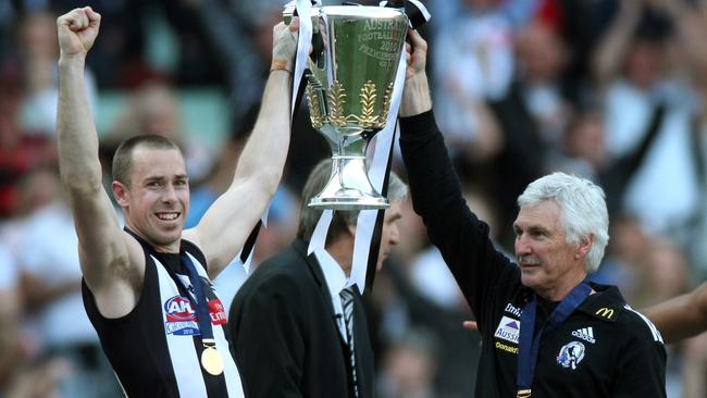 Nick Maxwell and Mick Malthouse lift the 2010 premiership cup.