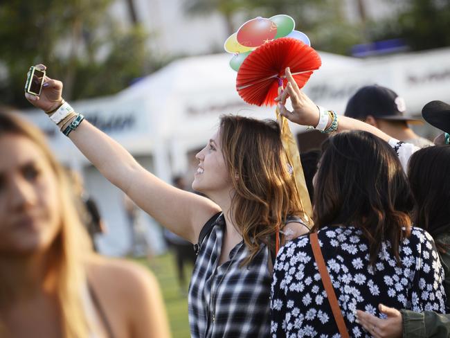 Strike the pose ... a festival-goer takes a selfie without the aid of a “selfie stick” — the items have been controversially banned from this year’s event. Picture: AFP PHOTO / ROBYN BECK